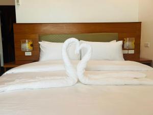 a bed with two swans made out of towels at Terra Verde Resort Guindulman Bohol in Guindulman +11 photos