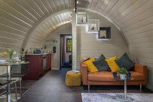 a living room with a couch and an archway at Foxes Den in Hankerton
