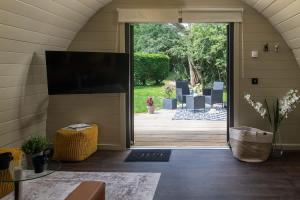 a living room with a large sliding glass door at Foxes Den in Hankerton