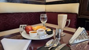 a table with a plate of food and a drink at Le caire Hotel & suits in Cairo