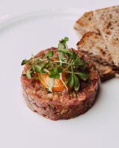 a piece of meat with an egg and some bread at The Crown in Martley +15 photos