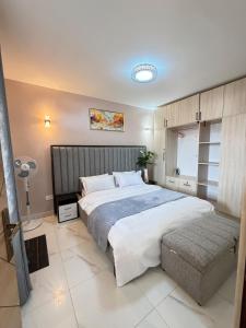 a bedroom with a large bed in a room at Plush stays UG in Buwate
