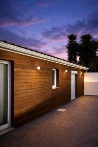 a wooden garage with two doors on the side at Entre Raizes in Remédios
