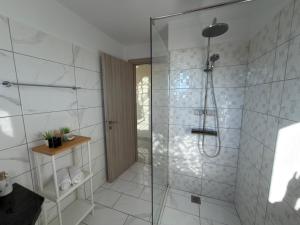 a bathroom with a shower with a glass door at Freesia Grand Sea View Residence in Sarláta +23 photos