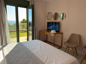 a bedroom with a bed and a desk and mirror at Freesia Grand Sea View Residence in Sarláta