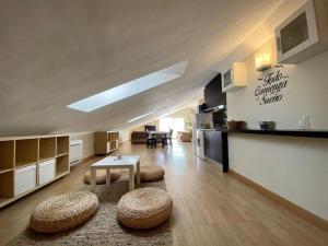 a large living room with a table and two stools at Exclusive Beachfront Penthouse in Almayate Alto