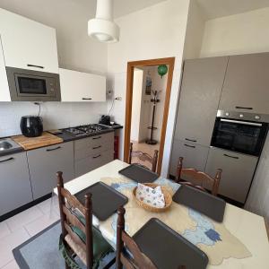 a kitchen with a table and chairs and a kitchen with a stove at La casa di nonna Gianna in Gonnesa +17 photos