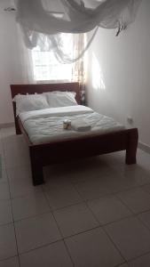 a bed sitting in a bedroom with a window at Jad Captains Hotel in Machakos