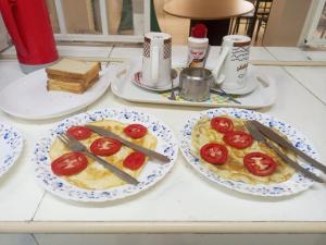 a table with two plates of food with tomatoes on them at Jad Captains Hotel in Machakos
