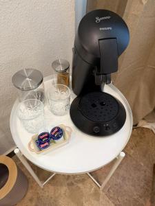 a coffee maker on a table with glasses on it at VTZ The Orus Factory Hotel - Parking Muy Económico in Zaragoza