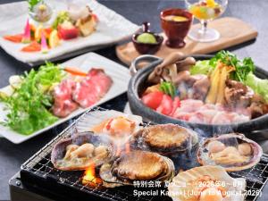 a bunch of food on a table with plates of food at KAMENOI HOTEL Oarai in Oarai