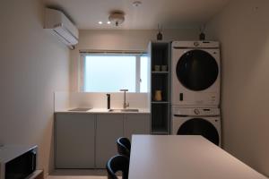 a kitchen with a sink and a dishwasher at Covon Stay in Busan