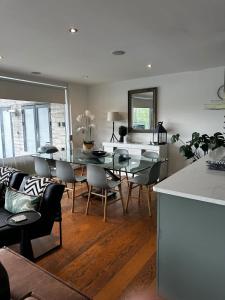 a kitchen and dining room with a table and chairs at Malachite in South Cerney