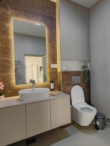 a bathroom with a sink and a toilet and a mirror at Motel Adut Boleč in Donja Kapija