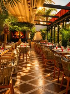 a restaurant with tables and chairs in a building at Hivernage Marrakech in Marrakesh