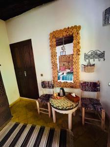 a room with a mirror and a table and a bed at Riad Dar Abi in Essaouira