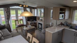 a kitchen and living room of a caravan at The Speculation Inn - 3 Bedroom Static Caravan in Pembroke