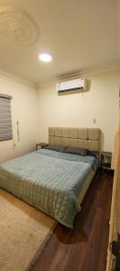 a bedroom with a large bed in a room at شقق الفيصل in Al Khobar