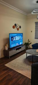 a living room with a large flat screen tv at شقق الفيصل in Al Khobar
