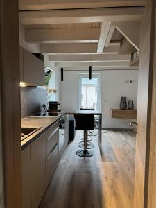 a kitchen with a table and a stool in it at Fichtennest in Sundern
