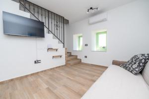 a living room with a couch and a flat screen tv at Sant'Antonio in Orlec
