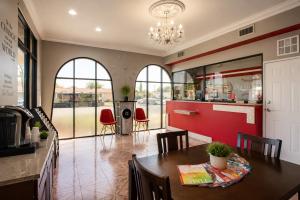 a kitchen and dining room with a table and chairs at Big A Motel & Suites Near Disneyland Orange County in Orange