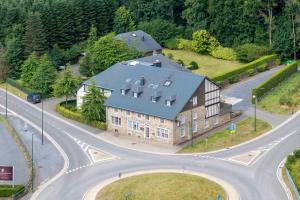 an overhead view of a house on a road at La Barrière de Transinne in Libin