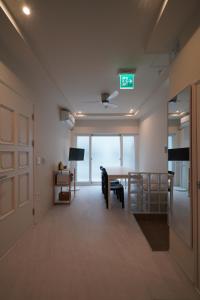 an empty room with a dining room table and a door at Covon Stay in Busan