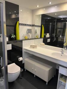 a bathroom with a sink and a toilet and a mirror at Villa 't Haasduin in Wijk aan Zee +78 photos