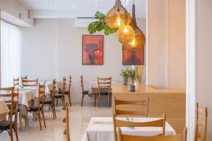 a dining room with tables and chairs and a chandelier at Alda Seaview Hotel in Cervia +148 photos