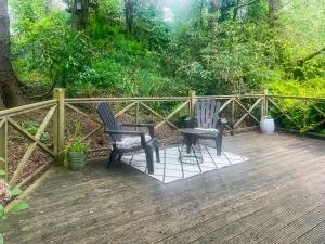 two chairs and a table on a wooden deck at The Signal Box in Girvan
