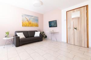 a living room with a couch and a door at first Apart in Erlangen