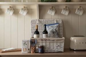 a basket of wine and cheese on a counter at Hill View in Burford +31 photos