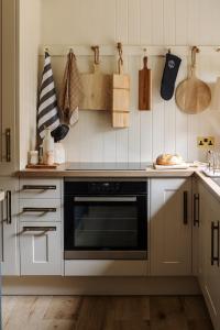 a kitchen with a stove top oven in a kitchen at Hill View in Burford