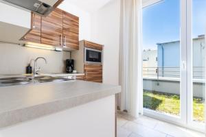 a kitchen with a counter and a large window at first Apart in Erlangen