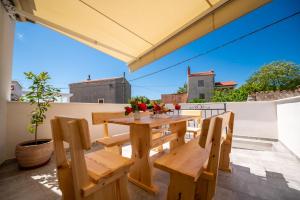 a wooden table and chairs on a patio at Sant'Antonio in Orlec