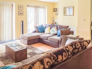 a living room with a couch and a table at Little Acorns in Great Malvern