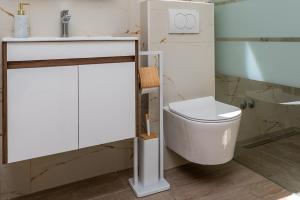 a bathroom with a white toilet and a sink at Sant'Antonio in Orlec +43 photos