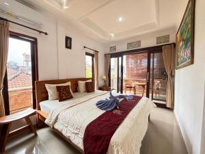 a bedroom with a bed and a large window at Wahadi homestay in Ubud