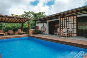 a house with a swimming pool and a patio at Villa Adara by Araw Residences in Luksuhin