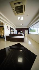a large room with a kitchen and a counter at LH Plaza Hotel in Chapecó