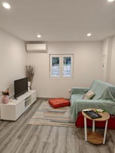 a bedroom with a bed and a flat screen tv at Marca 34 in Monção