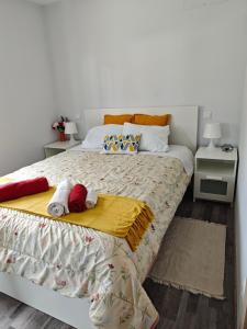 a bedroom with a bed with two towels on it at Marca 34 in Monção