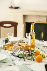 a table with a bottle of wine and glasses on it at Kosta Villa Alykes in Lefkimmi