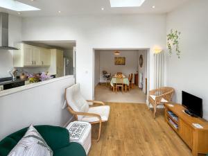 a living room with a couch and a dining room at Rosemary House in Broadstairs
