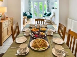 a table with breakfast food on it in a dining room at Rosemary House in Broadstairs