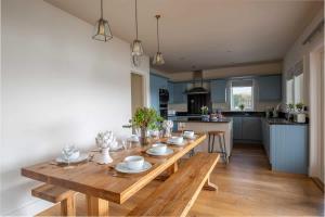 a wooden table in a kitchen with a dining room at Summer Lake in South Cerney