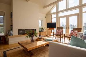 a living room with a couch and a table at Summer Lake in South Cerney +56 photos