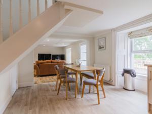 a dining room with a table and chairs and a couch at Dalnaglar Cottage - Uk30260 in Cray