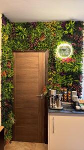 a room with a door with a wall covered in flowers at Luxehaus MCR in Manchester